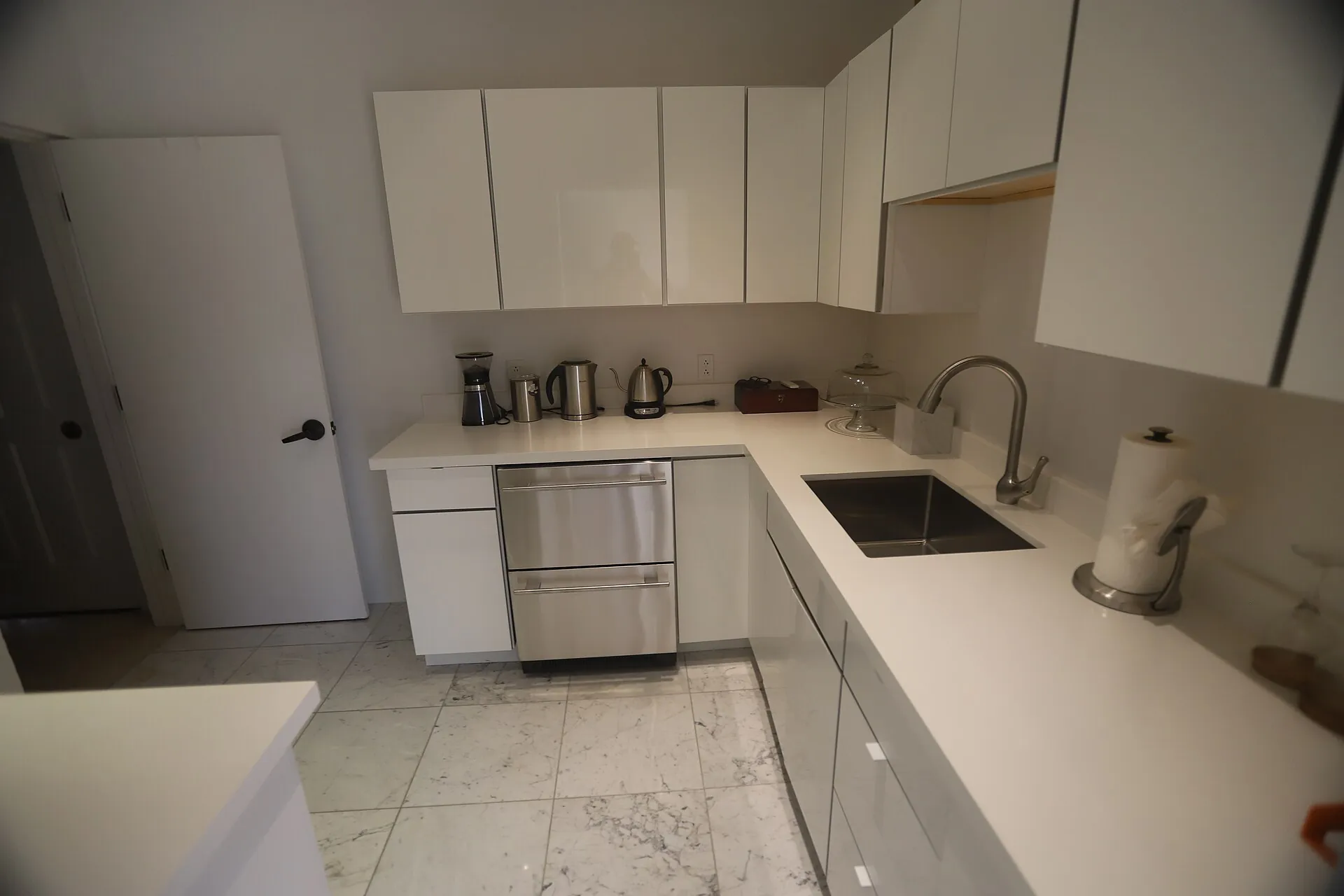 Stainless-steel built-in refrigerator drawers in a modern kitchen — high-end refrigerator repair