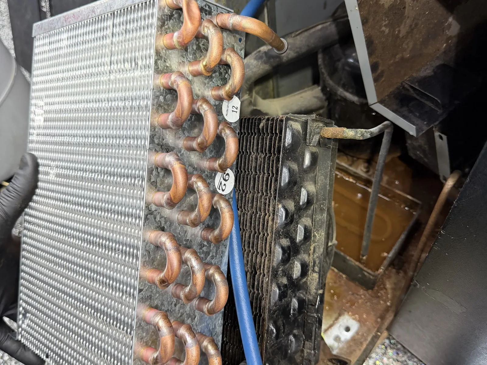 Condenser coil pulled for cleaning during an air conditioning repair