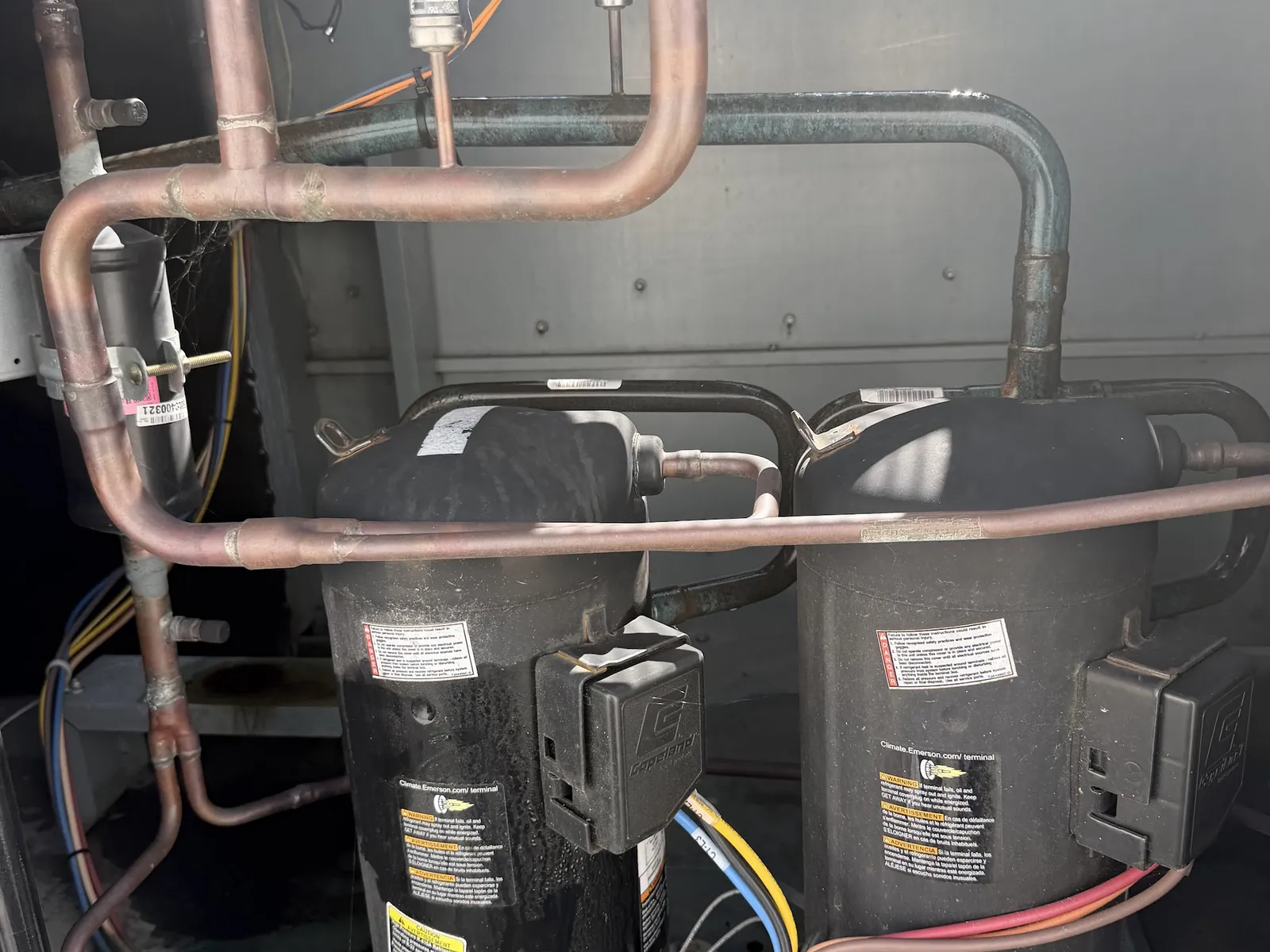 Compressor and copper refrigerant lines inside a refrigeration unit