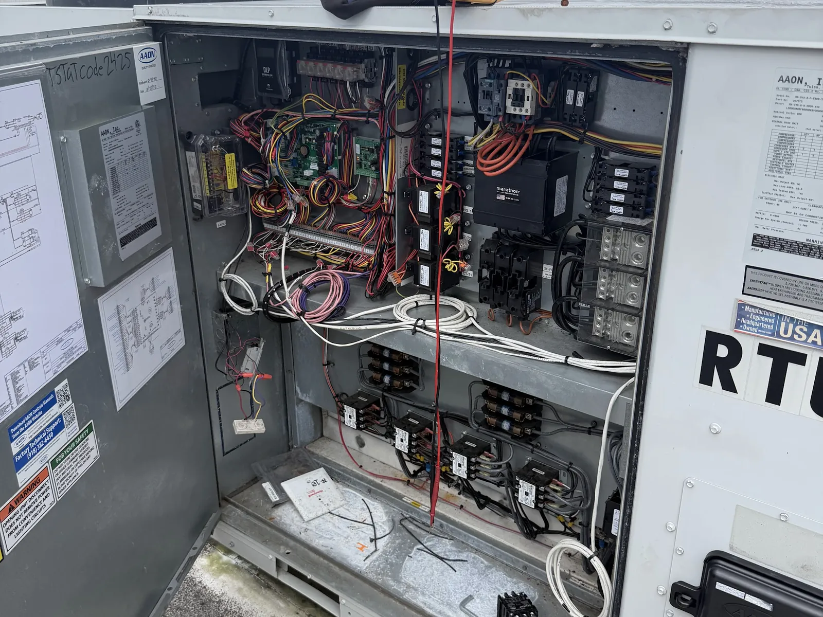 Open control panel of a rooftop air conditioning unit during a repair