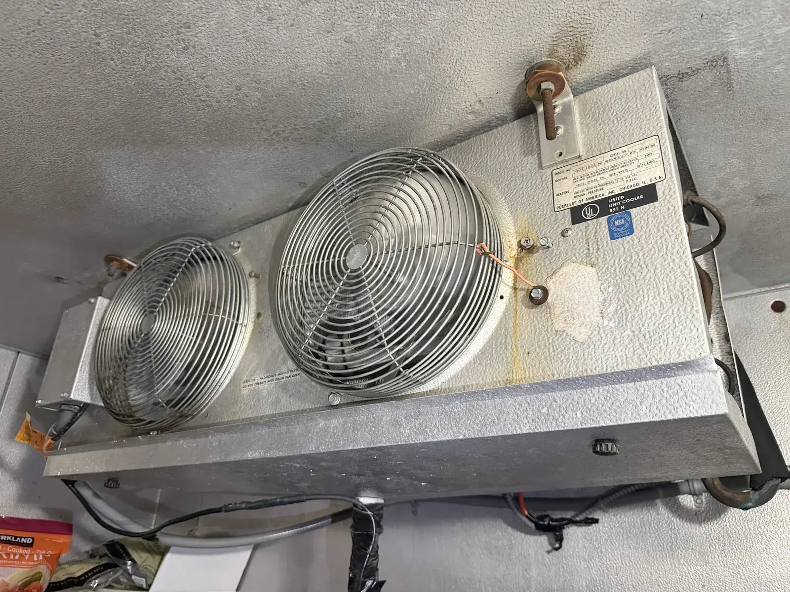 Twin-fan evaporator unit mounted on the ceiling inside a walk-in cooler